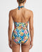 Woman wearing a floral high-waisted swimsuit on a plain background