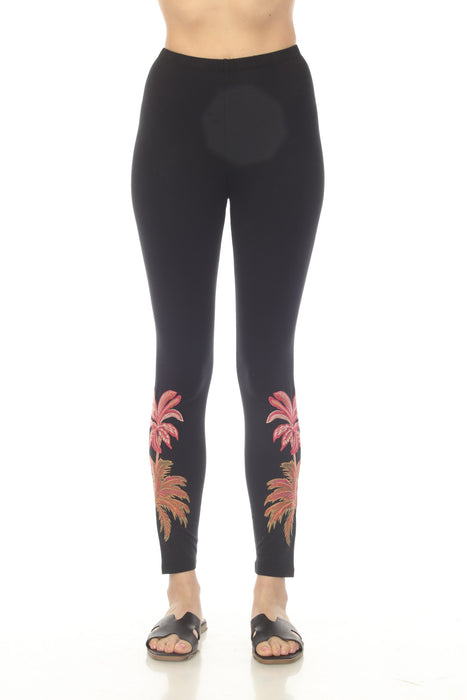 Woman wearing a black legging with palm tree embroidery from Johnny Was