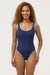 Woman wearing a blue swimsuit against a white background