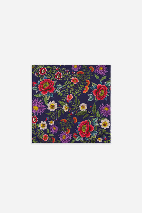 A square fabric or paper napkin featuring a vibrant, dense floral pattern on a dark navy blue background, shown flat against a light gray backdrop.