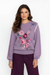 Woman wearing a purple sweater with floral embroidery and contrasting whipstitch from Johnny Was