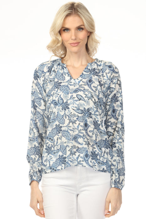 Woman wearing a blue paisley floral v-neck blouse with long raglan sleeves from Charlie B