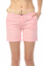 Woman wearing a pink twill shorts with roll up cuff and belt from Charlie B