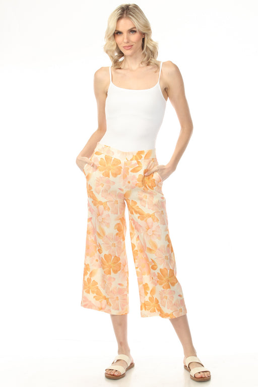Woman wearing orange floral printed wide leg cropped pants with side pockets from Charlie B