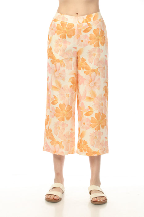 Woman wearing orange floral printed wide leg cropped pants with side pockets from Charlie B