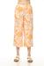 Woman wearing orange floral printed wide leg cropped pants with side pockets from Charlie B
