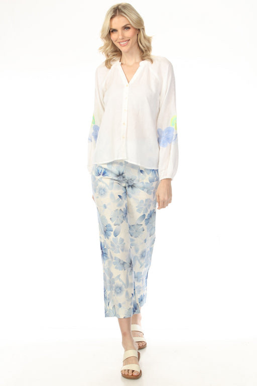 Woman wearing white cropped wide leg pants with blue floral print from Charlie B