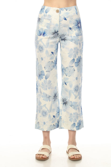 Woman wearing white cropped wide leg pants with blue floral print from Charlie B