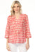 Woman wearing a patterned v-neck henley blouse with 3/4 sleeves and chest pocket from Charlie B