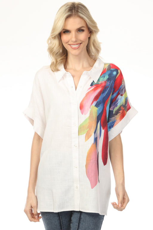 Woman wearing white button-up top with colorful feathers print and dolman sleeves from Charlie B
