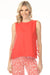 Woman wearing bright orange sleeveless top with round neck and side ties from Charlie B