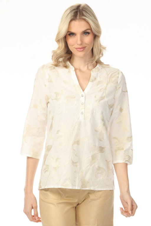 Woman wearing white popover top with gold floral embroideries and 3/4 sleeves from Charlie B
