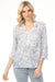 Woman wearing a blue v-neck henley blouse with a subtle pattern and roll-up sleeves from Charlie B