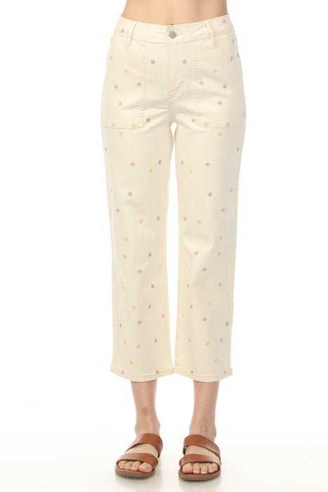 Woman wearing beige cropped jeans with scattered floral embroideries and narrow leg from Charlie B