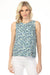Woman wearing a printed linen blend sleeveless top with off-center slit from Charlie B