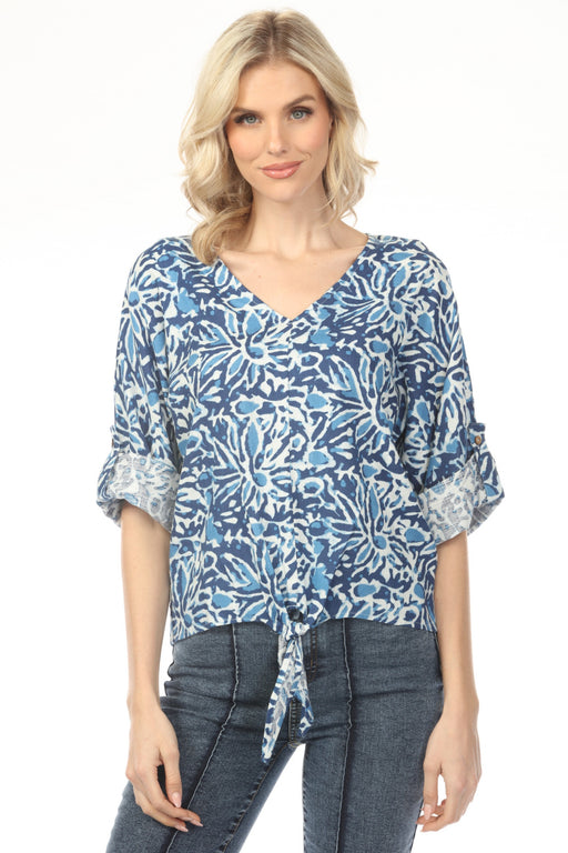 Woman wearing blue reef-printed v-neck top with front tie and 3/4 roll-up sleeves from Charlie B