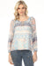 Woman wearing a lightweight Fair Isle patterned raglan sleeve blouse from Charlie B