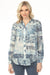 Woman wearing a blue paisley patterned long sleeve top with button front and rounded hem from Charlie B