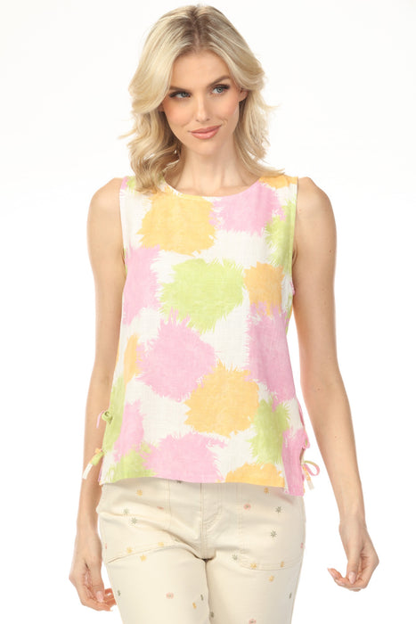 Woman wearing a multicolored splatter patterned sleeveless top with side ties from Charlie B