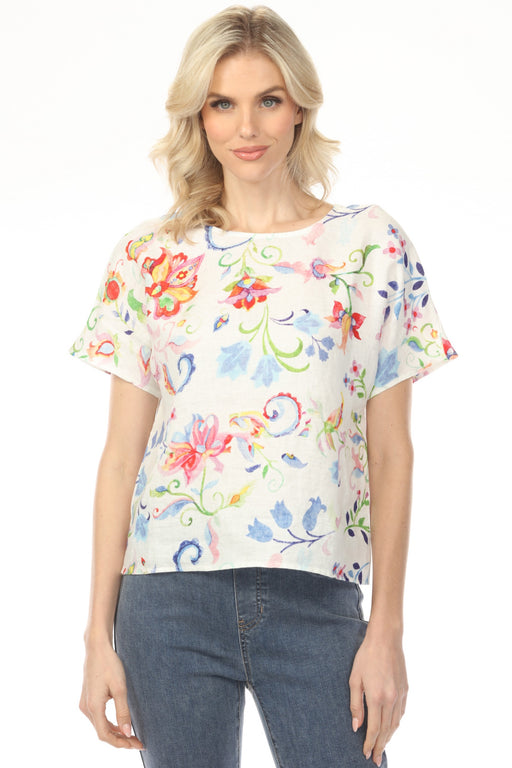 Woman wearing colorful floral printed top with short dolman sleeves from Charlie B