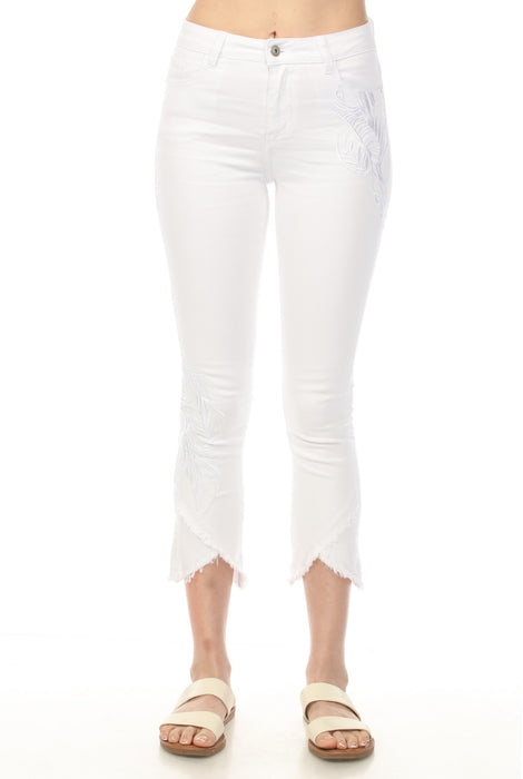 Woman wearing white cropped jeans with frayed tulip hem and embroidery from Charlie B