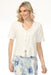 Woman wearing white floral embroidered cover-up with eyelets and front ties from Charlie B