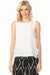 Woman wearing white sleeveless top with round neck and side ties from Charlie B