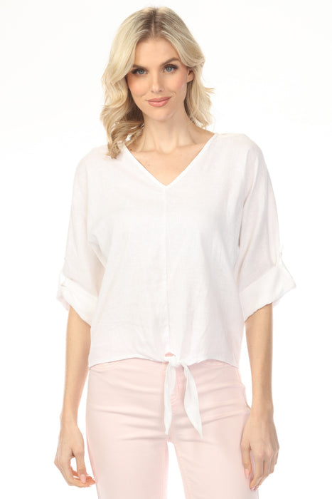 Woman wearing a white v-neck blouse with a front tie detail and roll-up sleeves from Charlie B
