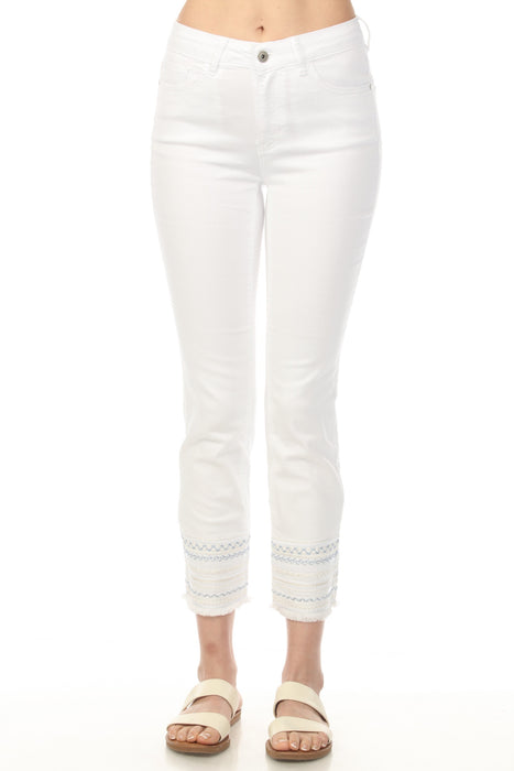 Woman wearing a white slim cropped jeans with fringe embroidered hem from Charlie B