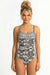 Woman wearing a black and white patterned one-piece swimsuit with sweetheart neck from Johnny Was