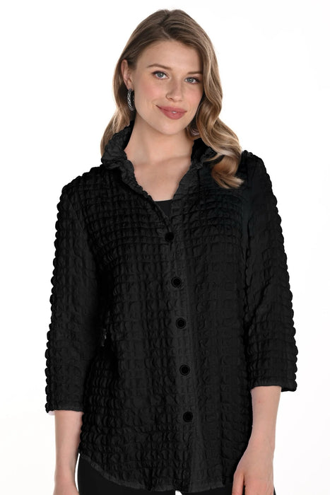 Woman wearing a black textured blouse with 3/4 sleeves and button front from Frank Lyman