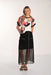 Woman wearing a floral top and black skirt with sheer overlay on a white background