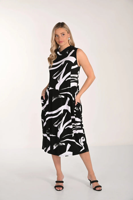 Woman wearing a black and white patterned dress on a white background
