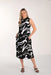 Woman wearing a black and white patterned dress on a white background