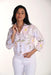 Woman wearing a floral blouse with a white background