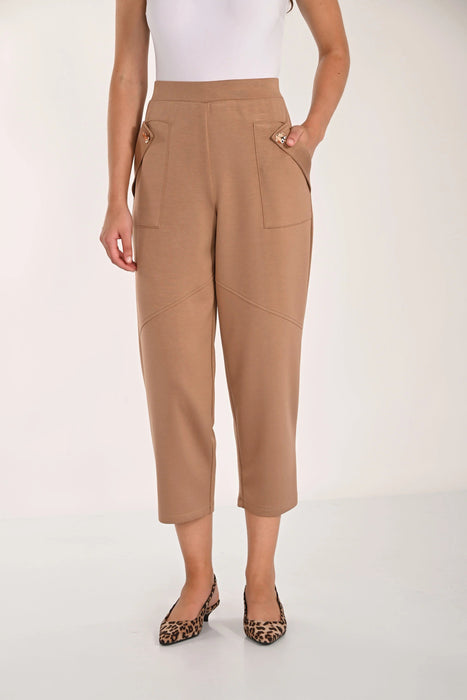 A model wearing high-waisted, cropped tan pants with decorative side pockets and leopard-print pointed flats, shown against a plain light background.