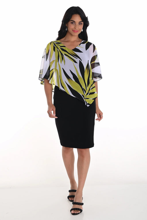 Woman wearing a knee-length black dress with an asymmetric leaf-printed chiffon overlay from Frank Lyman