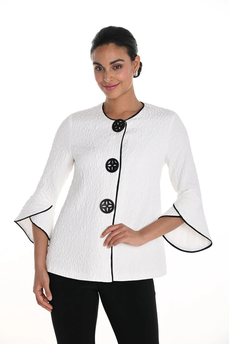 Woman wearing an off-white textured jacket with black buttons and trim from Frank Lyman