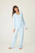 Woman wearing light blue pajama set with lace inset on the v-neck top and pant from PJ Salvage