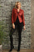 Woman wearing a red vegan leather moto jacket with zipper trim and grommet accent from Insight New York