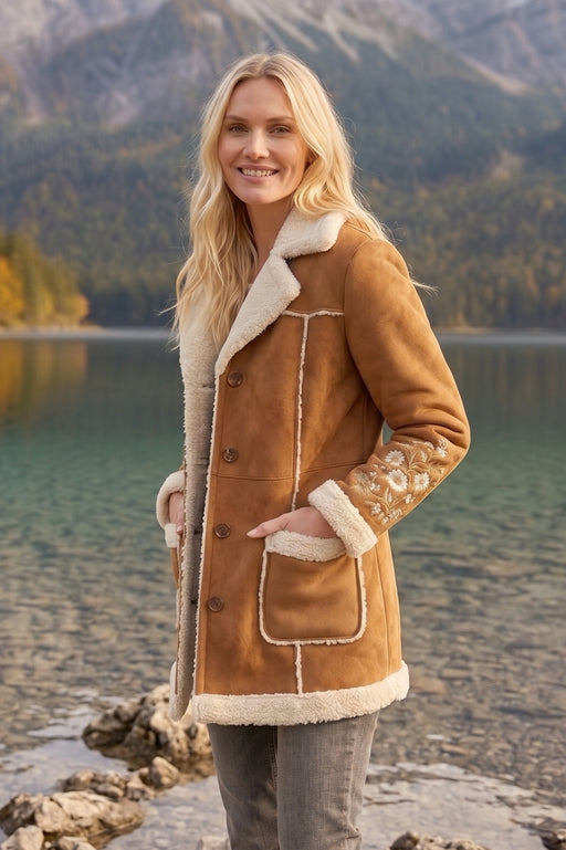 Woman wearing brown coat with sherpa trim and floral embroidery from Johnny Was