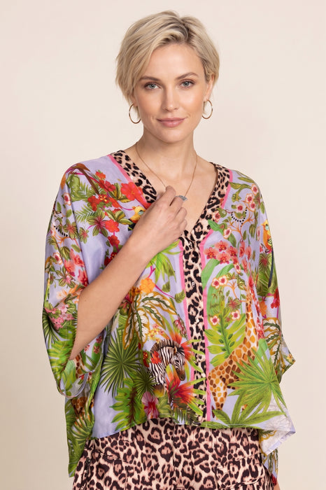 Woman wearing a colorful floral and leopard print top with v-neck and 3/4 sleeves from Johnny Was