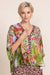Woman wearing a colorful floral and leopard print top with v-neck and 3/4 sleeves from Johnny Was