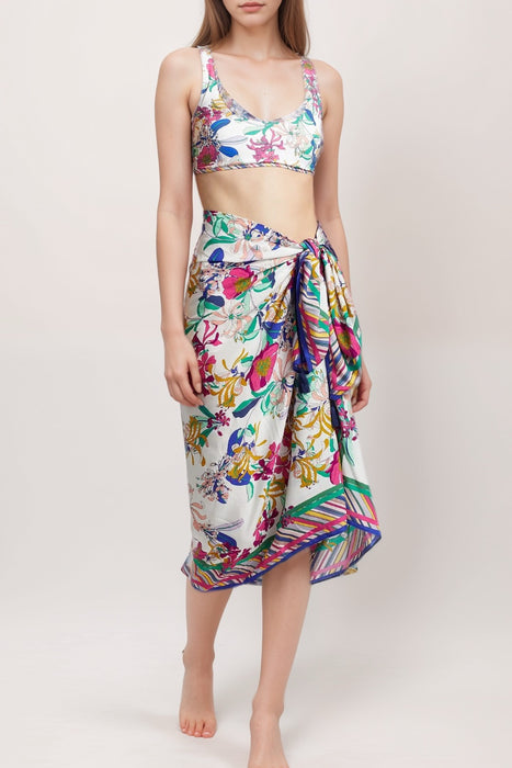 Woman wearing a colorful sarong with self-tie waist and colorful florals and stripes from Johnny Was