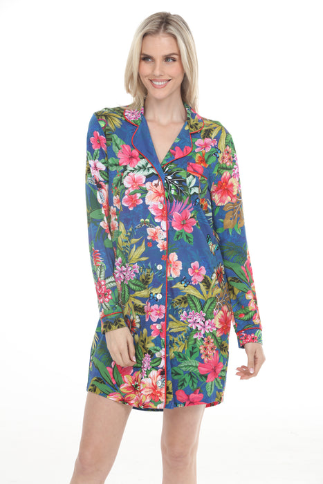 Woman wearing a blue button-down sleep shirt with colorful tropical floral print and long sleeves from Johnny Was