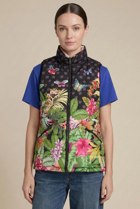 Woman wearing a tropical printed puffer vest with zip up front and pockets from Johnny Was