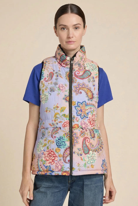 Woman wearing a paisley floral printed puffer vest with zip up front and pockets from Johnny Was