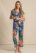 Woman wearing a matching blue floral sleepwear including a short sleeve top and crop pajama pants from Johnny Was