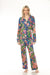 Woman wearing a colorful floral pajama set from Johnny Was