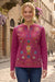 Woman wearing a pink embroidered long-sleeve top with henley neckline and raw seams from Johnny Was